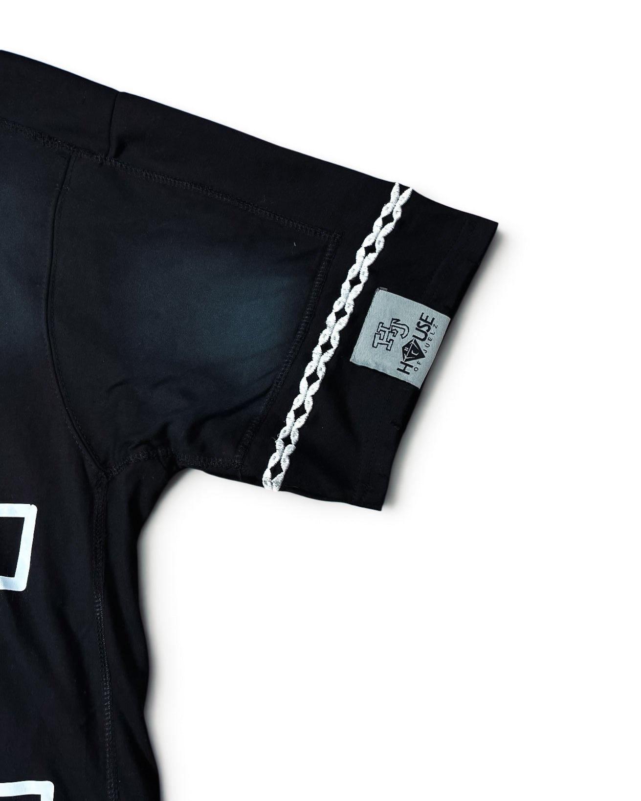 House of Juelz black double layer shirt sleeve stitching and label detail