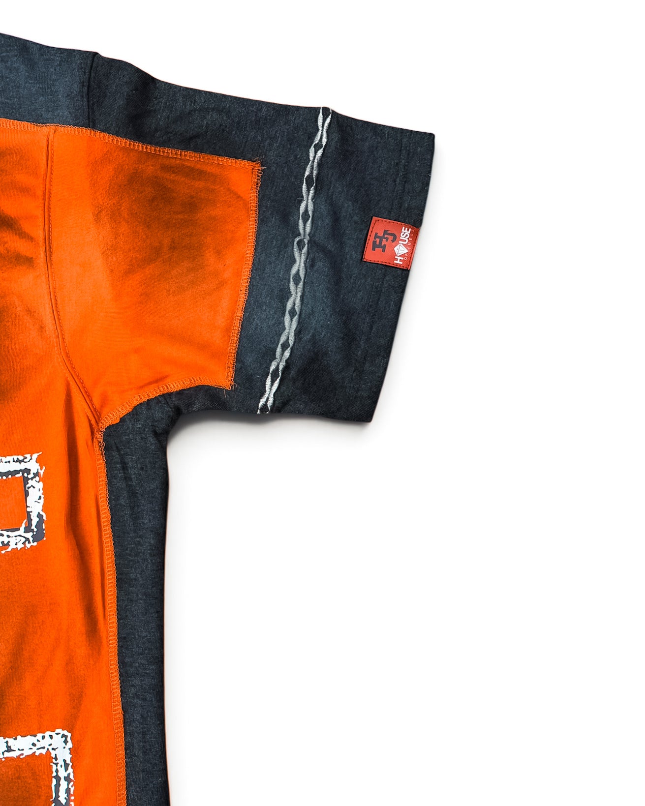 House of Juelz orange double layer shirt sleeve stitching and label detail